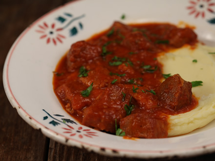 SLOW-COOKED PORK STEW WITH TOMATO AND HERBS SERVED WITH HORSE-RADISH MASHED POTATOES